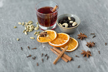 Image showing hot mulled wine, orange slices, raisins and spices