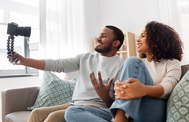 Image showing couple of video bloggers with camera at home