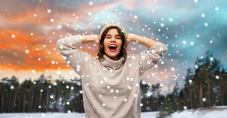 Image showing woman in hat and sweater over winter forest