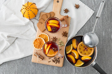 Image showing pot with hot mulled wine, orange slices and spices