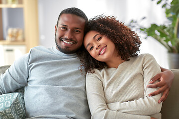 Image showing happy african american couple hugging at home