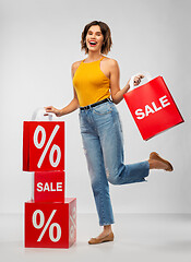 Image showing happy smiling young woman with shopping bags