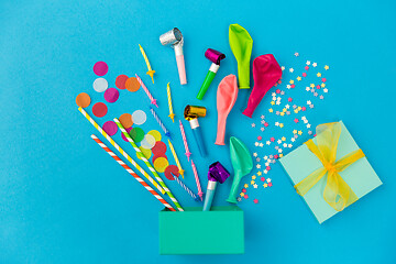 Image showing gift box and birthday party props on blue