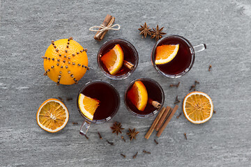 Image showing hot mulled wine, orange slices, raisins and spices