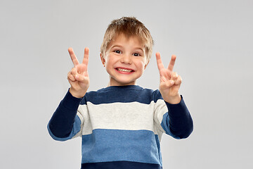 Image showing little boy in striped pullover showing peace