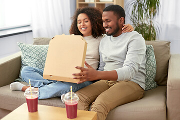 Image showing happy african american couple eating pizza at home