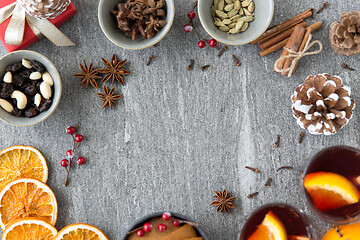 Image showing hot mulled wine, orange slices, raisins and spices