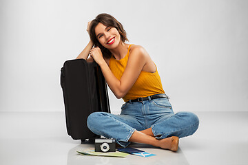 Image showing woman with travel bag, air ticket, map and camera