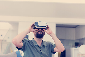 Image showing man with beard trying vr glasses