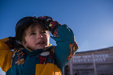 Image showing little boy having a problem with ski goggles