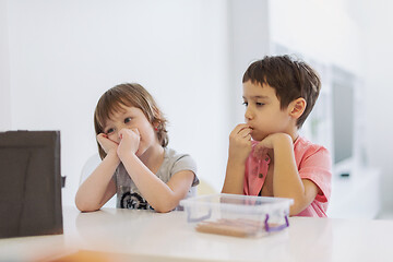 Image showing cute little brother and sister having fun at home