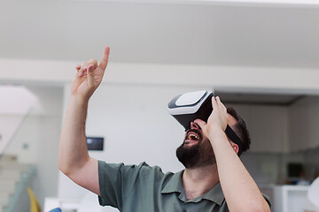 Image showing man with beard trying vr glasses