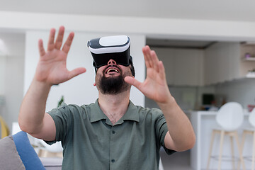 Image showing man with beard trying vr glasses