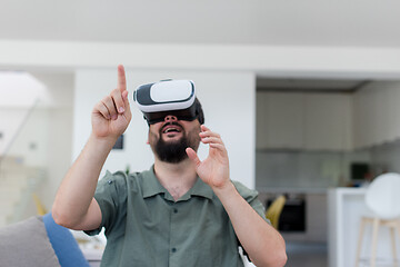 Image showing man with beard trying vr glasses