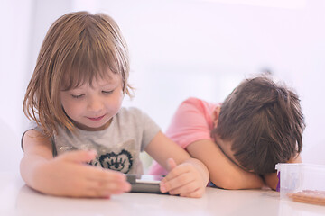 Image showing cute little brother and sister having fun at home