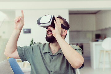 Image showing man with beard trying vr glasses