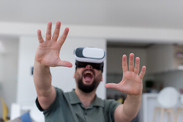 Image showing man with beard trying vr glasses