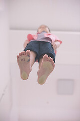 Image showing little boy standing on transparent glass floor