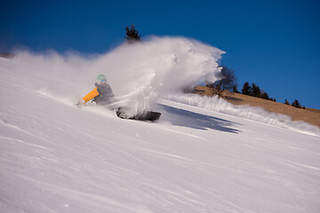 Image showing snowboarder crashes while carving down