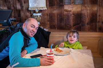 Image showing father his little son eating a pizza