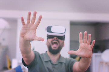 Image showing man with beard trying vr glasses