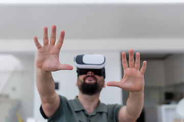 Image showing man with beard trying vr glasses