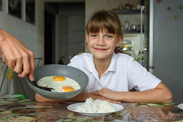 Image showing Mom made scrambled eggs for lunch for a hungry daughter