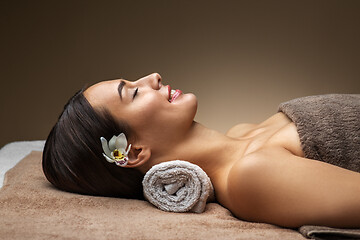 Image showing young woman lying at spa or massage parlor