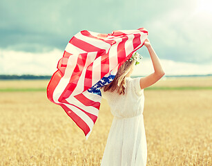 Image showing happy woman with american flag on cereal field