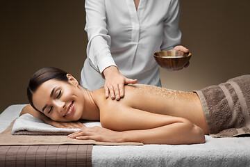 Image showing beautiful young woman having salt massage at spa