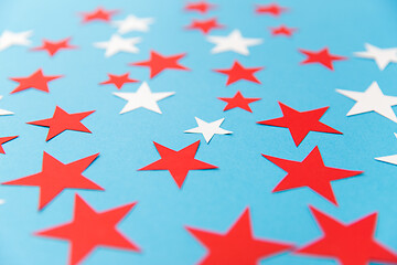 Image showing star shaped confetti decoration on blue background