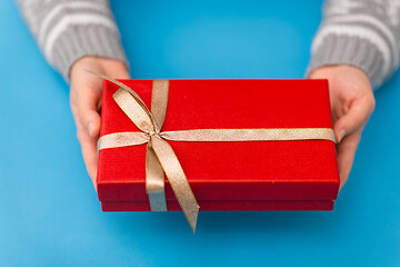 Image showing hands holding red christmas gift box