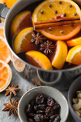 Image showing pot with hot mulled wine, orange slices and spices