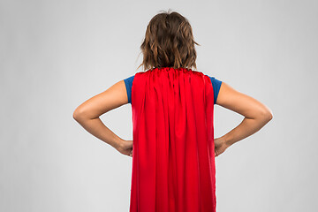 Image showing back view of young woman in red superhero cape