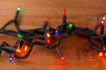 Image showing christmas garland lights on wooden background