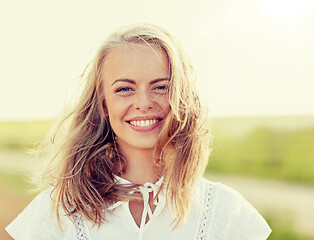 Image showing close up of happy young woman in white outdoors