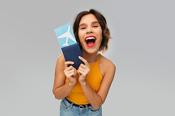 Image showing happy young woman with air ticket and passport