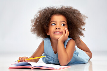 Image showing happy little african american girl with sketchbook