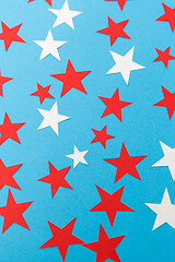 Image showing star shaped confetti decoration on blue background