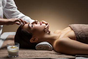 Image showing woman having face and head massage at spa