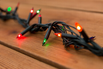 Image showing christmas garland lights on wooden background