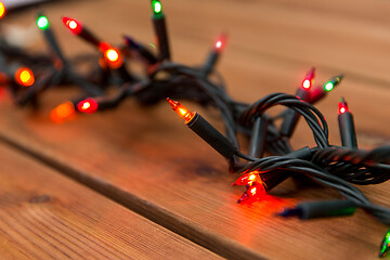 Image showing christmas garland lights on wooden background