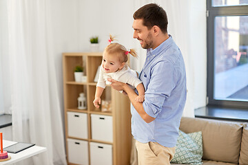 Image showing happy father playing with baby daughter at home