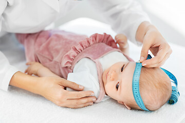 Image showing pediatrician doctor measuring bab\'s head at clinic