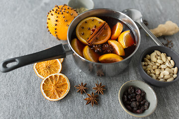 Image showing pot with hot mulled wine, orange slices and spices