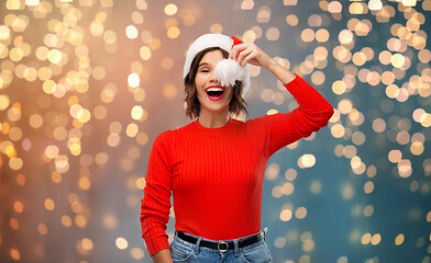 Image showing happy young woman in santa hat on christmas