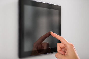 Image showing hand using tablet computer at smart home