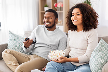 Image showing african couple with popcorn watching tv at home