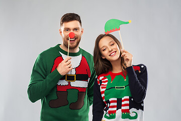 Image showing couple with christmas party props in ugly sweaters