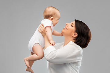 Image showing happy middle-aged mother with little baby daughter